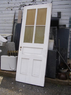 photo of painted white door, salvage yard