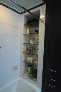 Photo of glass shelves inside tub area.