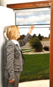 photo of retractable screen storm; woman lifting the panel.