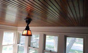 Dark wood beadboard porch ceiling