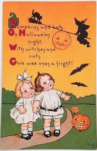 postcard with children, bats, and pumpkins
