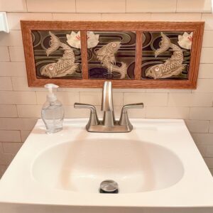 Framed fish tiles on wall.