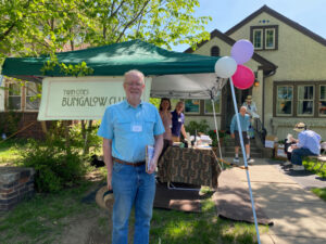 Marty, Deb, and Mike in front of a bungalow at the house tour welcome tent.