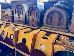 Old radios on shelf.