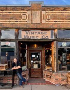 Holthus in front of the Vintage Music Company.
