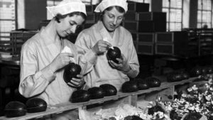 Two women decorating chocolate eggs