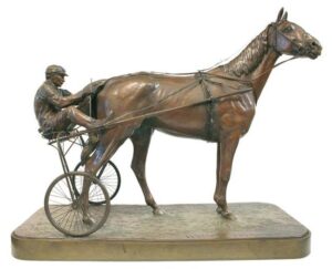 Sculpture of horse with man in cart.