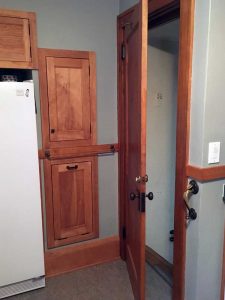 Photo of cupboards behind a door.